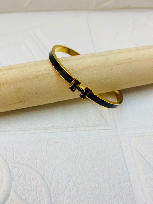 PULSERA DE ACERO RIGIDA HERMES DISE&Ntilde;O H NEGRO DORADO